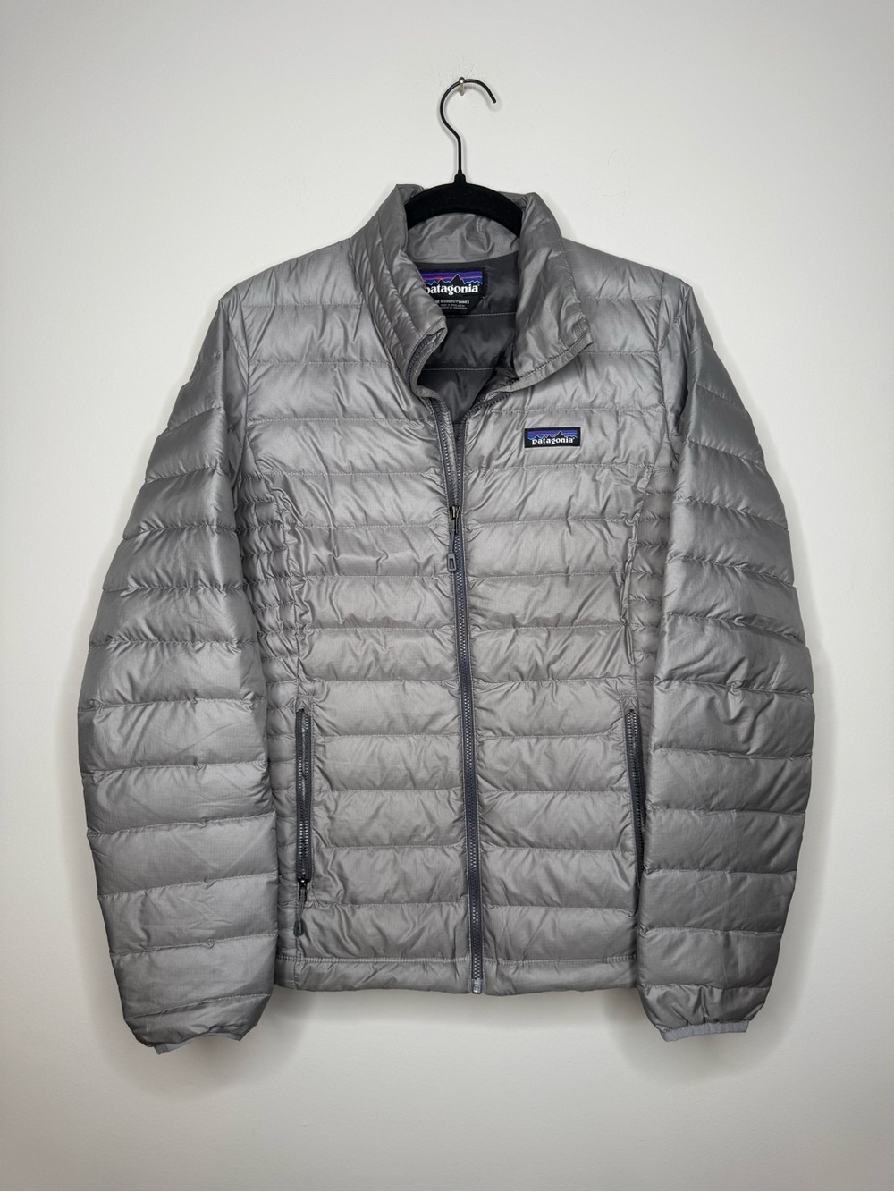 Patagonia Down Sweater jacket features horizontal quilting and a full-zip front.